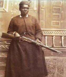 Sepia-tone photograph of Mary Fields, holding a rifle